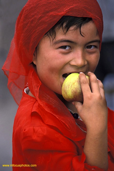 Young Girl Moslem Uighur Eating Red Apple Kashgar China